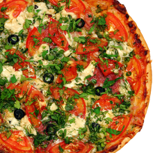 Pizza with tomatoes and greens